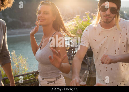 Young couple dancing at waterfront roof terrace party, Budapest, Hungary Stock Photo