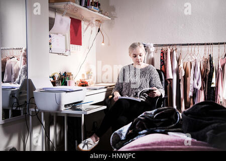 Female university student studying in the bedroom in her shared student house Stock Photo