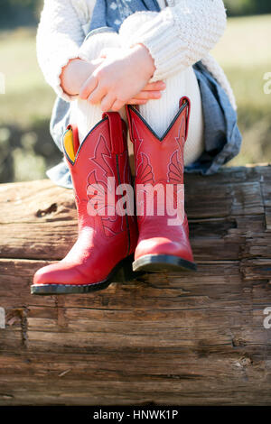 Woman wearing cowboy boots on lawn Stock Photo - Alamy