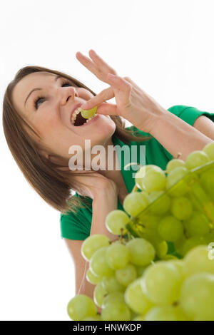 Model release, Junge Frau isst Weintrauben - young woman eats grapes Stock Photo