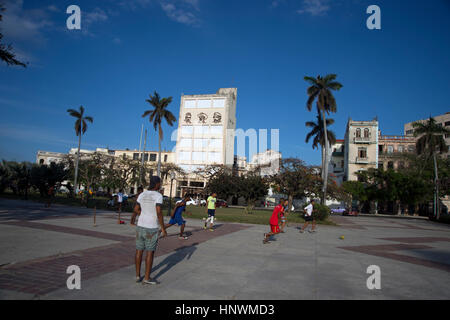 Group of Cuban teenagers playing football on the street Havana Cuba Stock Photo