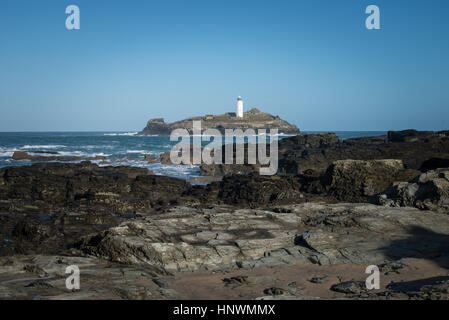 Godrevy Lighthouse, a white lighthouse on a small island off the coast of Cornwall near St Ives, UK. Stock Photo
