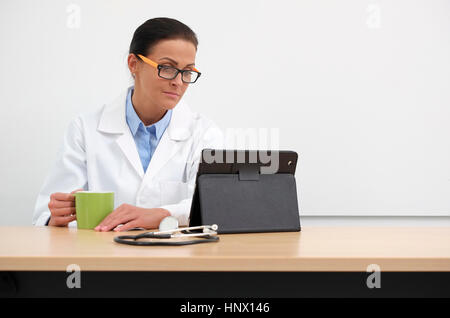 female doctor in medical centre using tablet computer Stock Photo