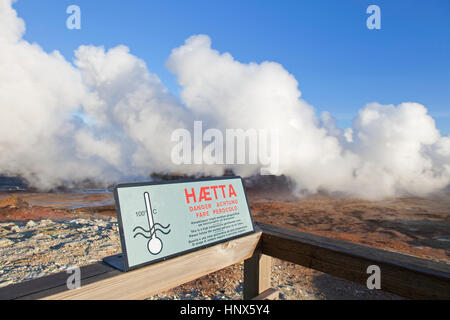 Warning sign and steam vents / fumaroles at Gunnuhver, geothermal area and center of the Reykjanes Volcanic System, Iceland Stock Photo