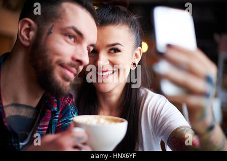 Couple in cafe taking selfie Stock Photo
