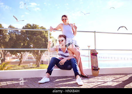 Couple taking selfie on promenade smiling Stock Photo