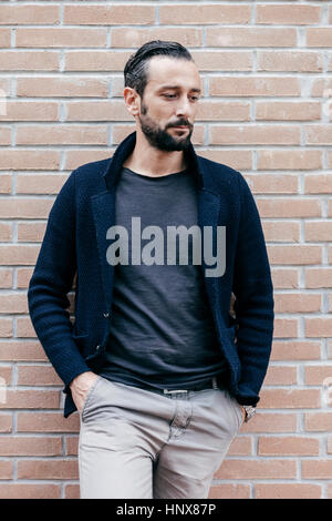 Man with hands in pockets looking away Stock Photo