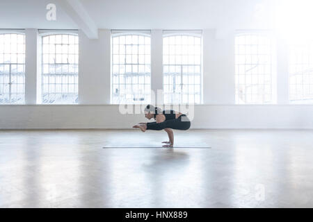 Woman in dance studio in yoga position Stock Photo