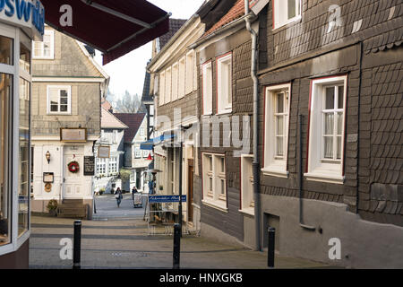 HATTINGEN, GERMANY - FEBRUARY 15, 2017: Two unidentified women walk through a narrow lane between historic half-timbered houses Stock Photo