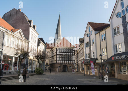 HATTINGEN, GERMANY - FEBRUARY 15, 2017: Unidentified pedestrants cross an old place with view at the historic town hall Stock Photo