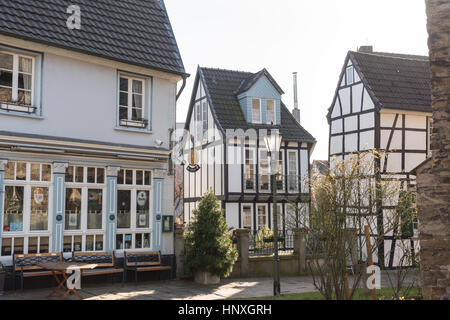 HATTINGEN, GERMANY - FEBRUARY 15, 2017: Two bigger historic half-timbered houses frama narrow one that hosts a modern apartment today Stock Photo