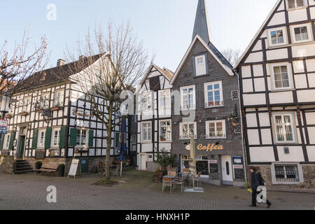 HATTINGEN, GERMANY - FEBRUARY 15, 2017: An unidentifed women passes a historic lane through historic downtown Stock Photo
