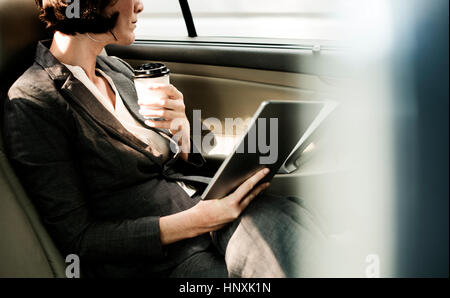 Businesswoman Using Tablet Car Inside Stock Photo