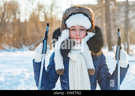 Cross-country skiing woman doing classic nordic cross country skiing in trail tracks in snow covered forest Stock Photo