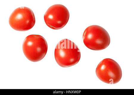 Falling plum tomatoes isolated on white background. Top view Stock Photo