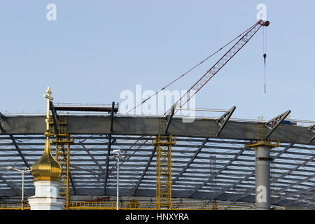 Tower cranes among dense urban areas in the construction of real estate Stock Photo