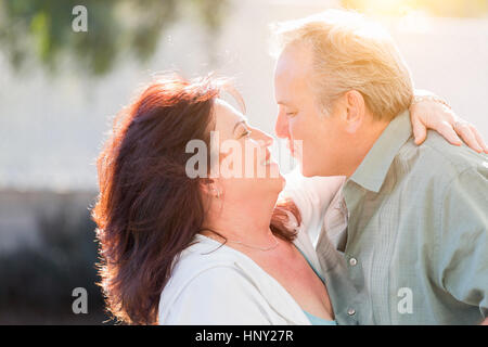 Happy Middle Aged Couple Enjoy A Romantic Slow Dance Outside. Stock Photo