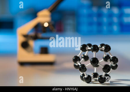 Model of molecule and microscope Stock Photo