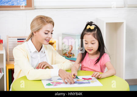 English teacher and kindergarten girl Stock Photo