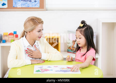 Foreign teacher and kindergarten girl Stock Photo