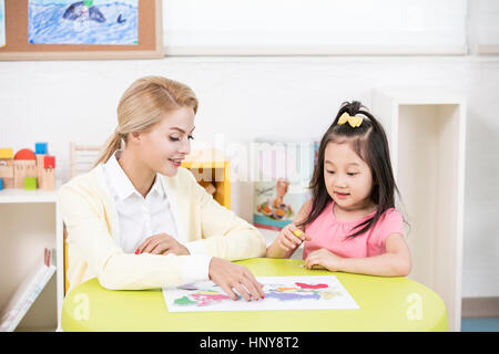 Foreign teacher and kindergarten girl Stock Photo