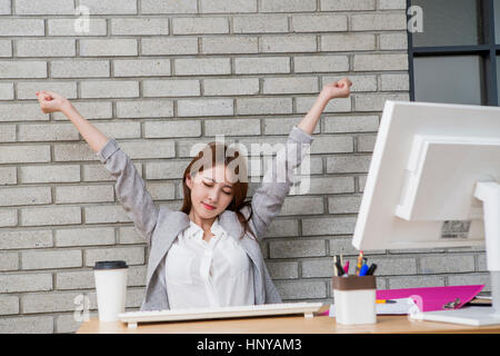 Businesswoman stretching arms Stock Photo