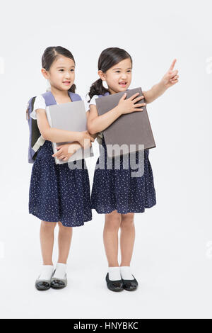 Smiling twin girls with books Stock Photo