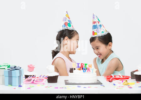 Smiling twin girls at birthday party