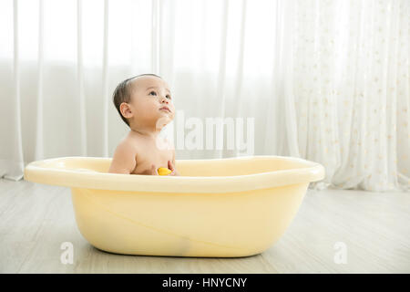 Baby boy in a tub Stock Photo