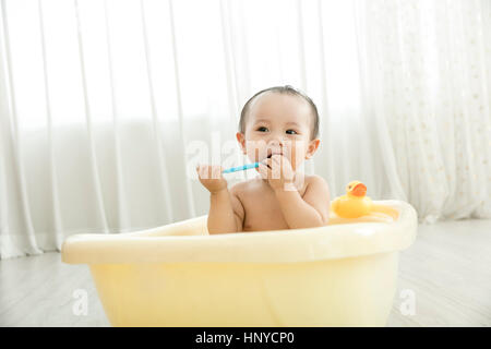 Baby boy in a tub Stock Photo