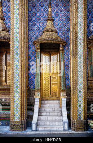 Golden doors of famous temple Wat Phra Kaew near royal palace in Bangkok, Thailand Stock Photo