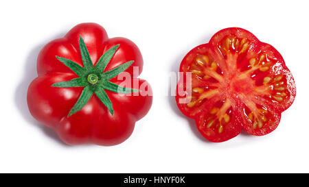 Fresh ripe ribbed heirloom tomato with sepal, whole and half. Top view, clipping paths, shadows separated Stock Photo