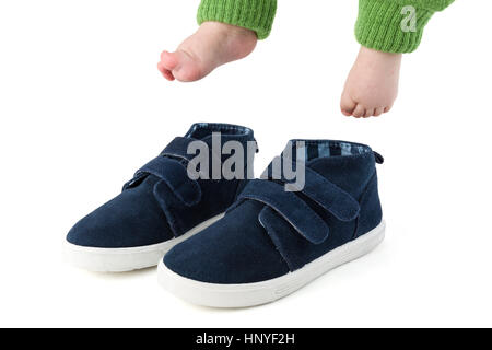 Baby feet with too big blue child shoes isolated on white studio shot