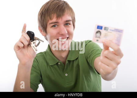 Model release , Junger Mann mit Autoschluessel und Fuehrerschein - young man with car key and driving licence Stock Photo
