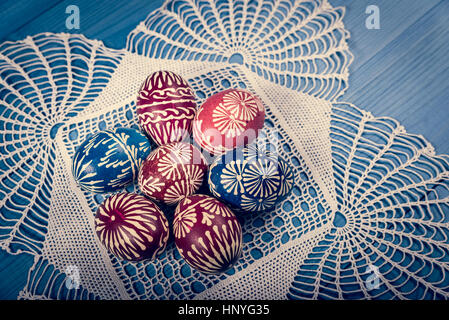 Group of hand painted easter eggs on the blue wooden surface Stock Photo