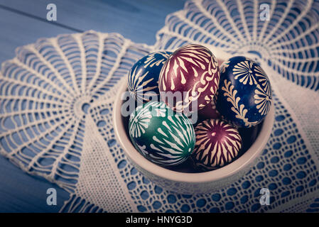 Group of hand painted easter eggs on the blue wooden surface Stock Photo