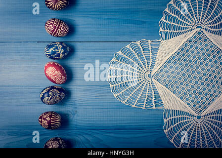 Group of hand painted easter eggs on the blue wooden surface Stock Photo
