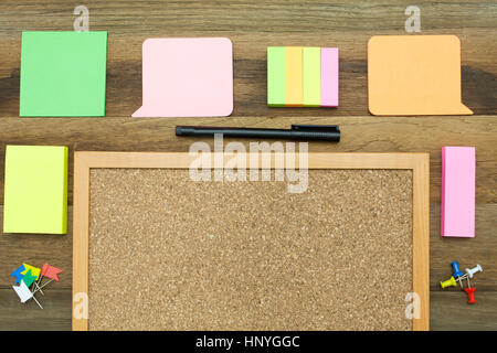 A colorful blank,sticky note paper around a notice board with wooden background Stock Photo