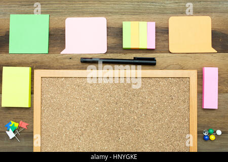 A colorful blank,sticky note paper around a notice board with wooden background Stock Photo