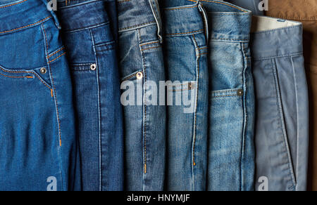 Stack of different blue jeans. Many jeans lay on shop sale Stock Photo