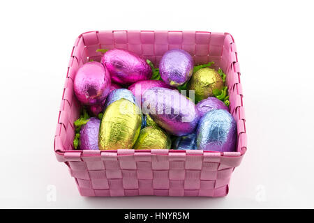 Multi-coloured Easter eggs in a pink basket Stock Photo