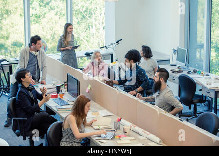 Professionals coworking in shared office space Stock Photo
