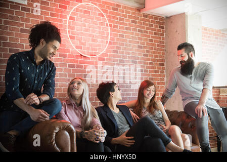 Group of friends hanging out on sofa Stock Photo