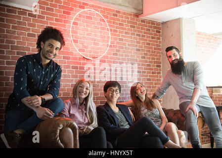 Group of friends hanging out on sofa, portrait Stock Photo
