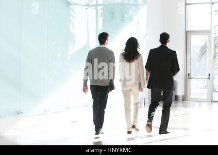 Business associates walking together in office Stock Photo