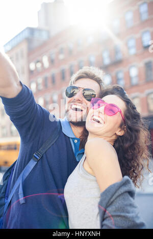 Happy young beautiful loving couple posing walking outdoors in park nature  take selfie by mobile phone. Stock Photo by ©Vadymvdrobot 285896816