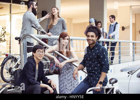 College students hanging out together outdoors Stock Photo