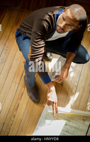Architect looking at blueprint Stock Photo