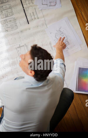 Architect looking at blueprint Stock Photo