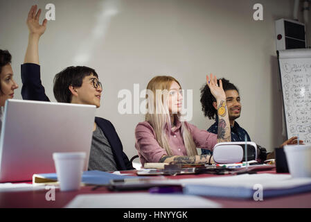 Office workers voting during business meeting Stock Photo